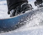 Snowboarder on a groomed slope practicing heel and toe edge control