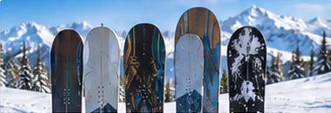 Several different snowboards standing side by side in the snow, like a snowboard quiver