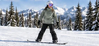 Snowboarder practicing edge control on a groomed beginner run