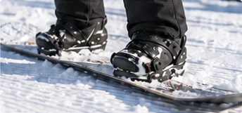 Snowboard boots and bindings on the toe edge on firm snow